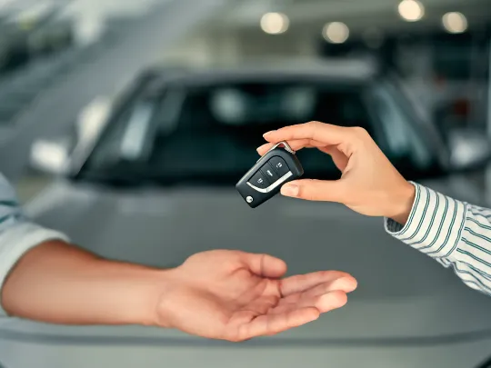 Boubyan customer receiving key for his new car financed through Boubyan Auto Finance.